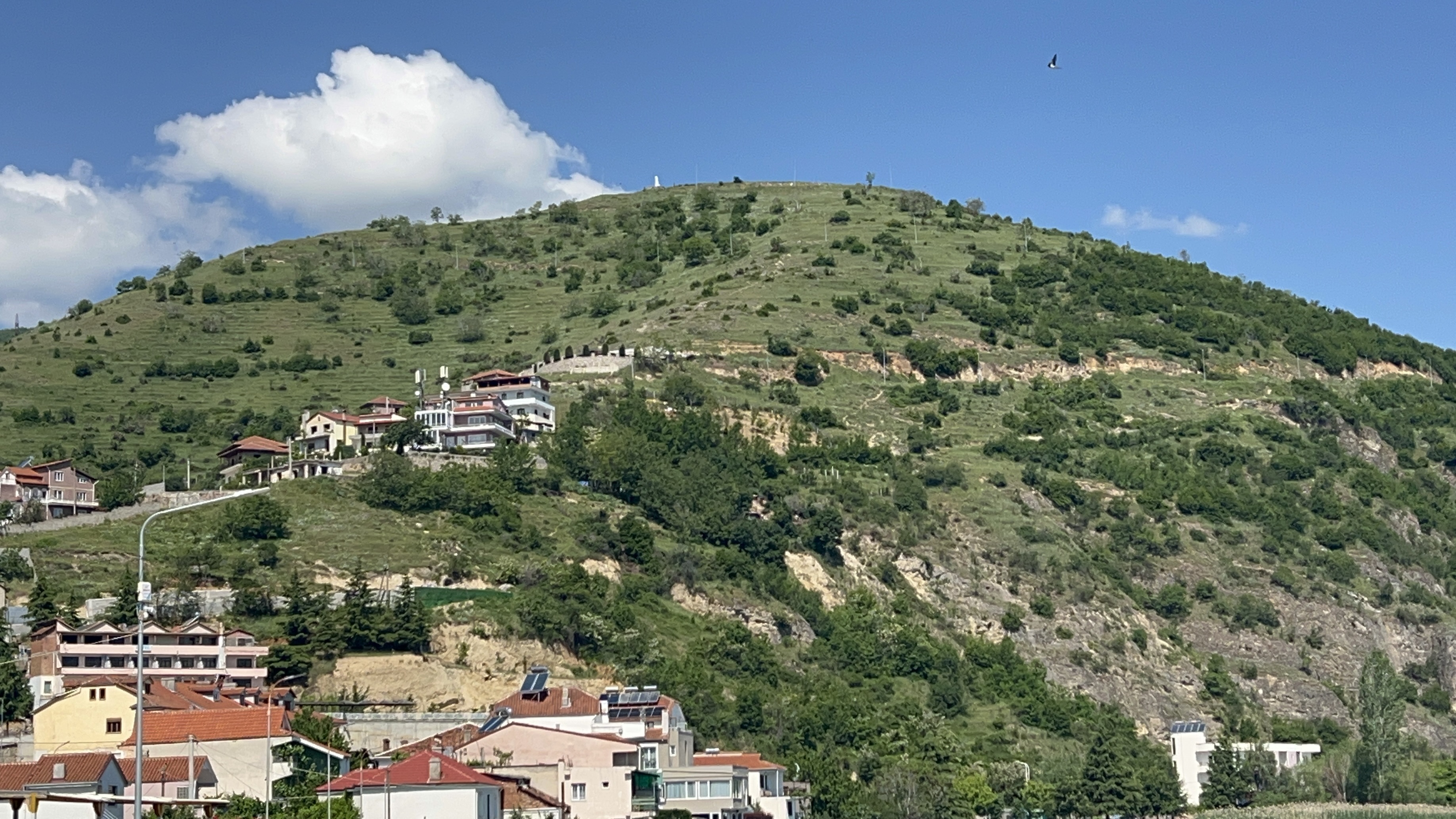 The hilltop ruins of Pogradec Castle seen from the town below